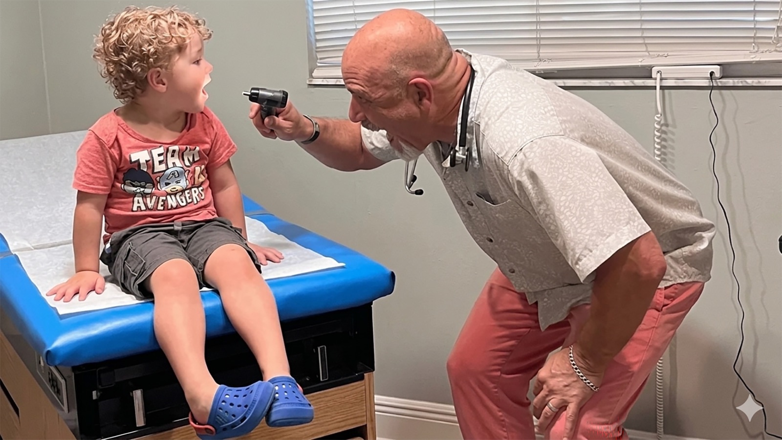 Dr. John examining a young patient at Island DPC